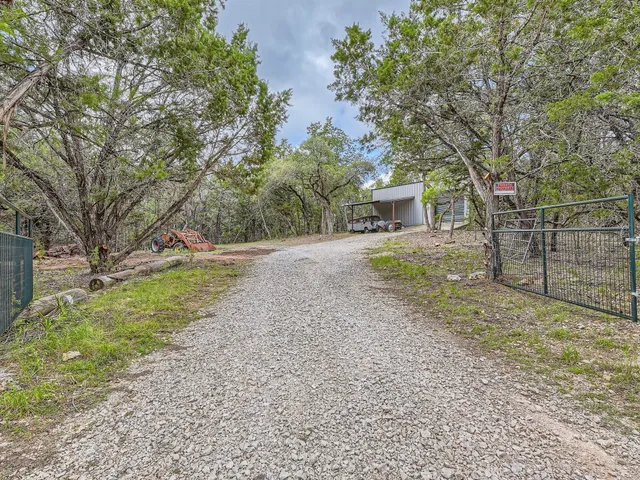 a view of a backyard with large trees