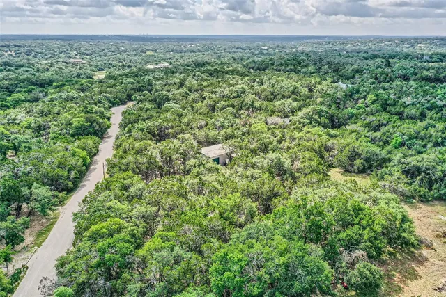 a view of a field of grass and trees