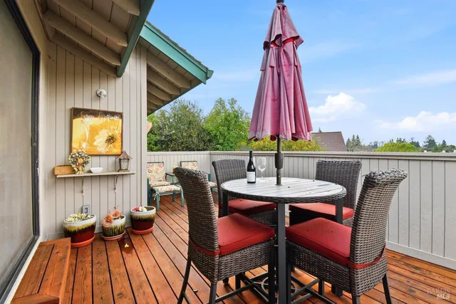 a view of balcony with a dining space and a chair