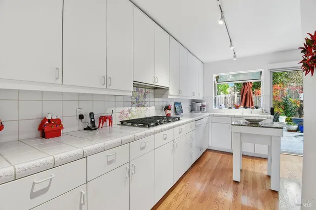 a kitchen with a white cabinets and white appliances