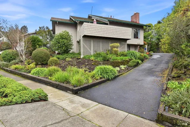 a view of a house with potted plants