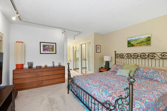 a bedroom with bed and wooden floor