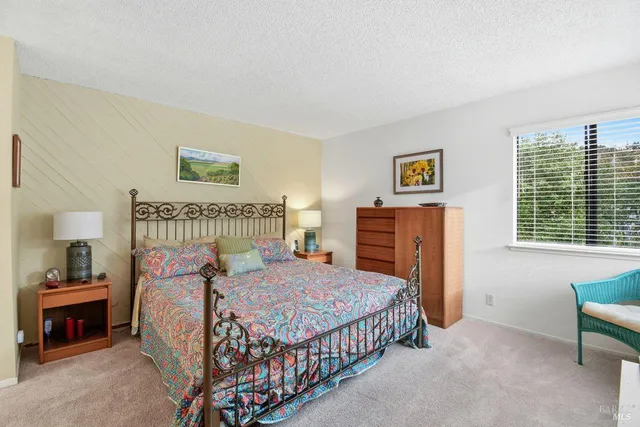 a bedroom with a bed and a table in it