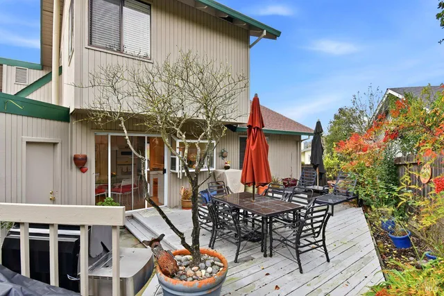 a backyard of a house with table and chairs