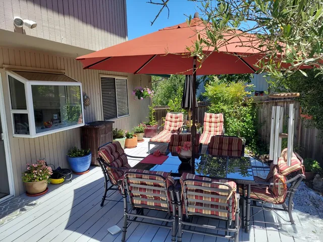a view of a patio with furniture and wooden floor