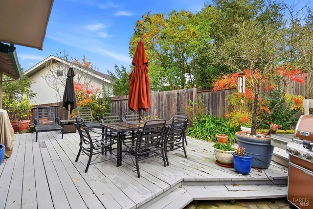 a view of outdoor sitting area with furniture and wooden floor