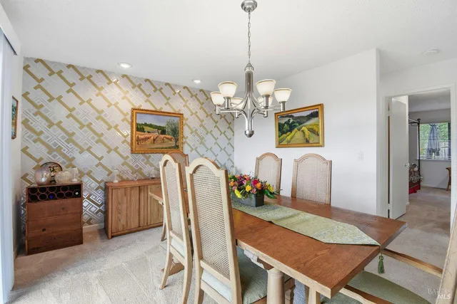 a view of a dining room with furniture and chandelier
