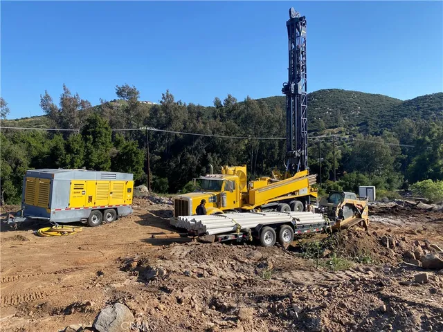 a view of a swimming pool with a patio and a garden