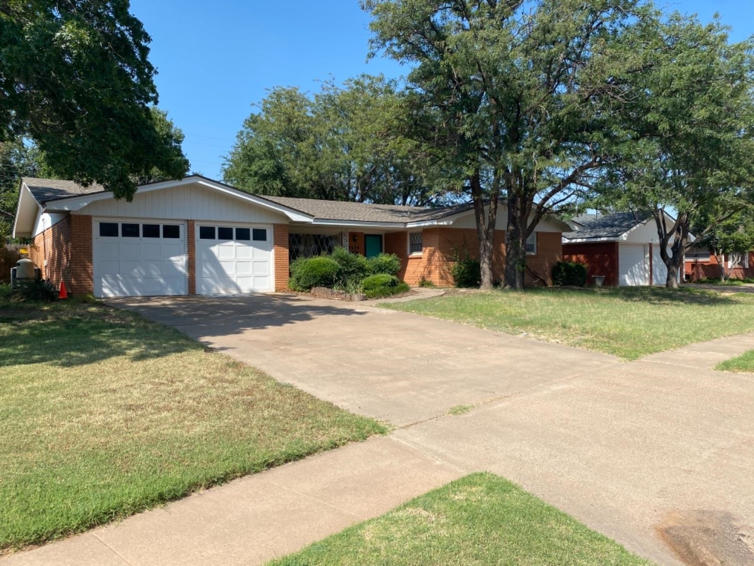 4604 28th Street Lubbock, TX 79410 - Photo 2 of 19 a front view of a house with a garden and trees