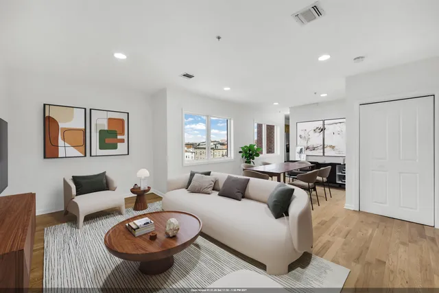 a living room with furniture a window and a table
