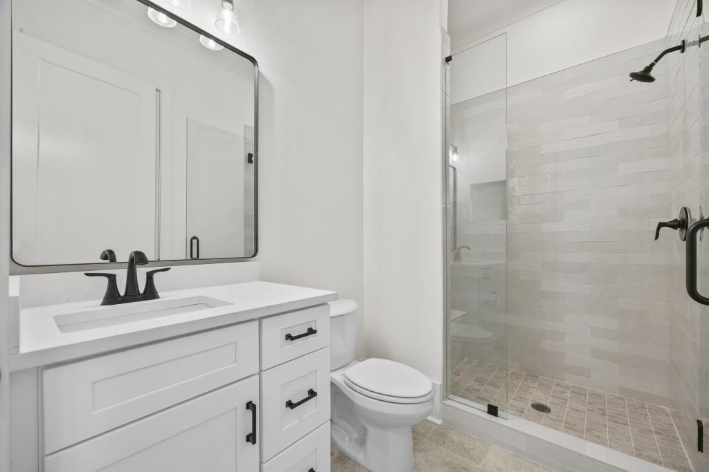611 Foster Park Lane Madison, GA 30650 - Photo 11 of 54 a bathroom with a sink toilet a mirror and shower
