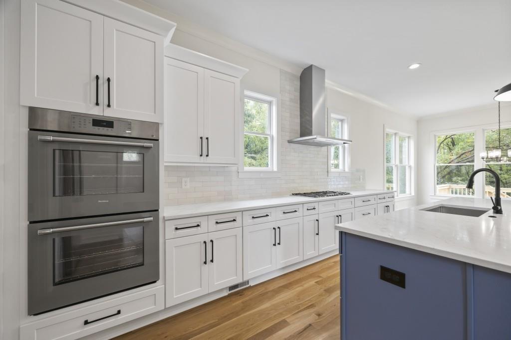 611 Foster Park Lane Madison, GA 30650 - Photo 17 of 54 a kitchen with granite countertop white cabinets white stainless steel appliances and sink