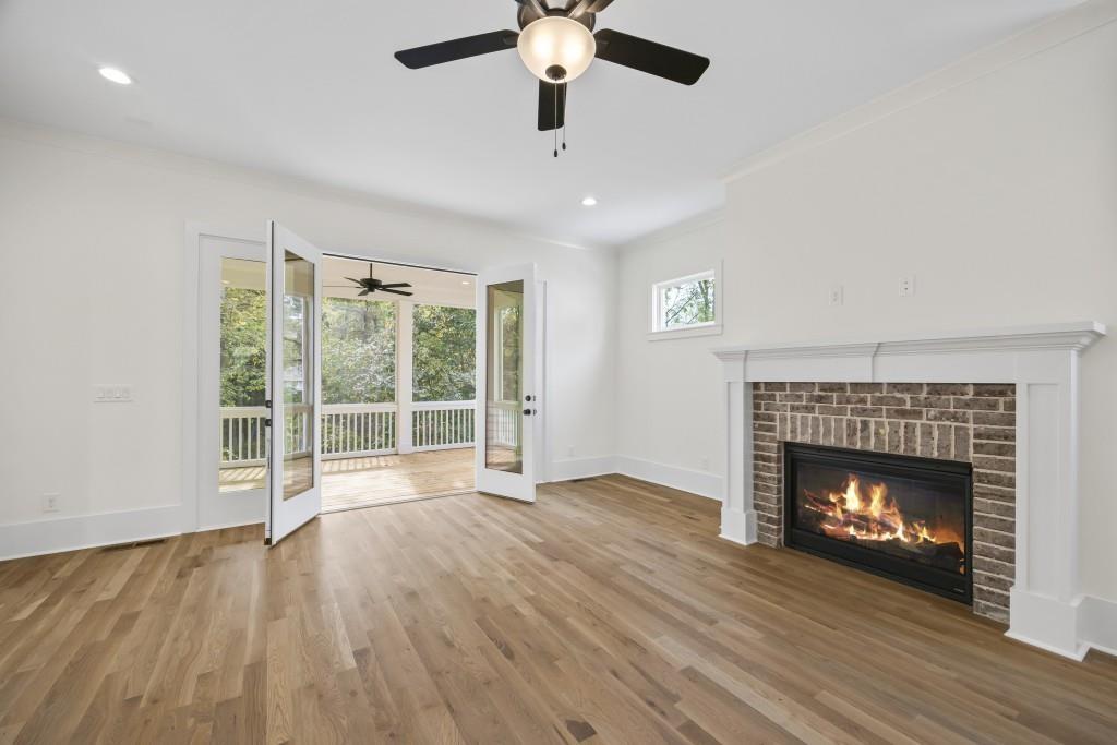 611 Foster Park Lane Madison, GA 30650 - Photo 20 of 54 a view of an empty room with wooden floor fireplace and a window