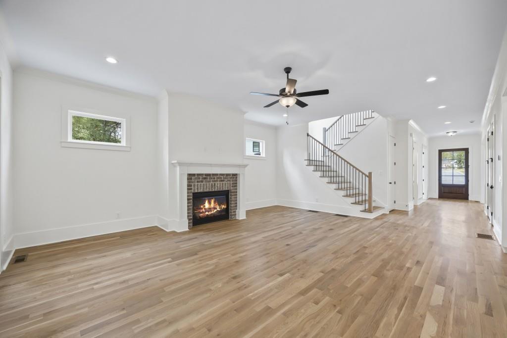 611 Foster Park Lane Madison, GA 30650 - Photo 21 of 54 a view of an empty room with wooden floor and a fireplace
