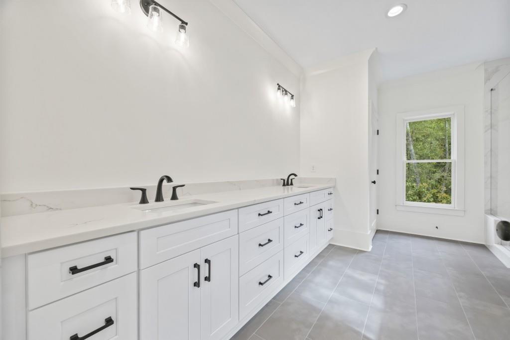 611 Foster Park Lane Madison, GA 30650 - Photo 29 of 54 a spacious bathroom with double sink a mirror and a window