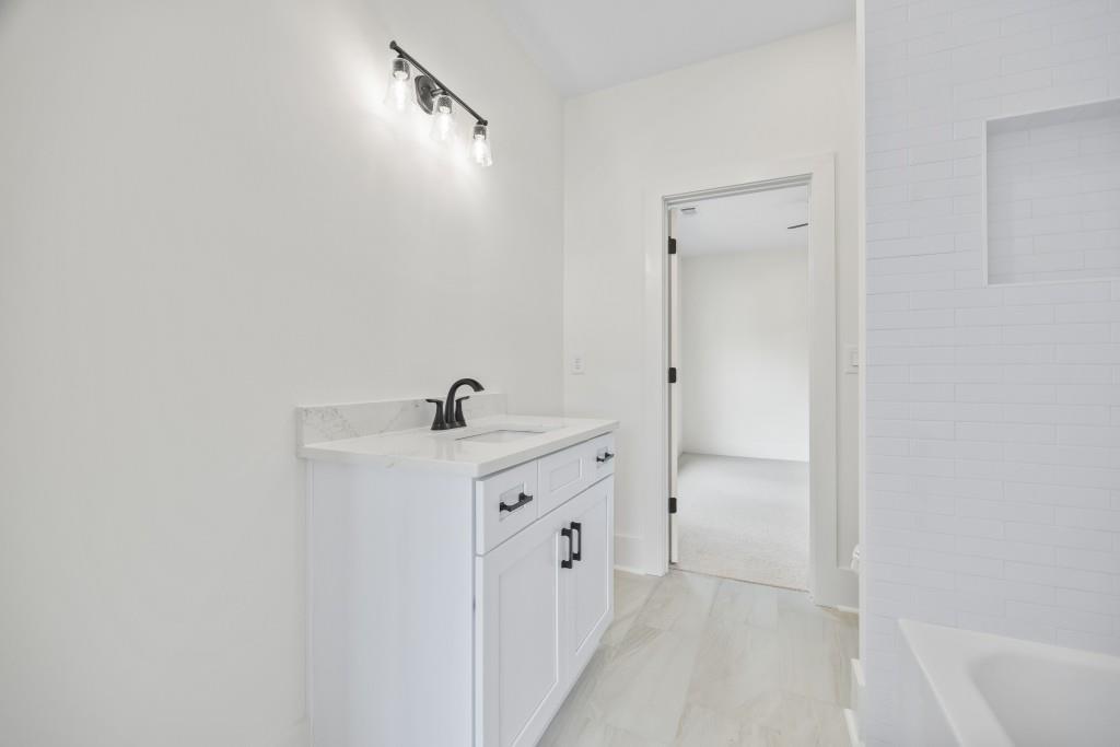 611 Foster Park Lane Madison, GA 30650 - Photo 40 of 54 a spacious bathroom with a double vanity sink and a mirror