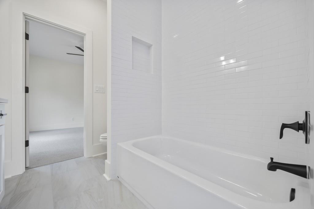 611 Foster Park Lane Madison, GA 30650 - Photo 41 of 54 a white bath tub sitting next to a shower