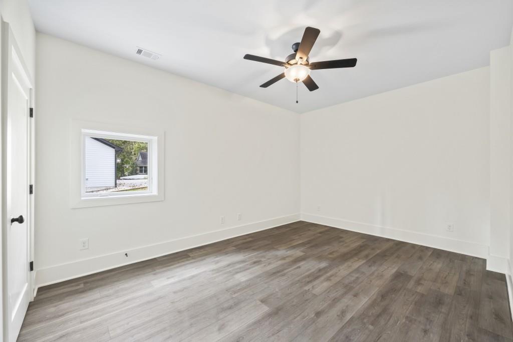 611 Foster Park Lane Madison, GA 30650 - Photo 44 of 54 an empty room with wooden floor closet and windows