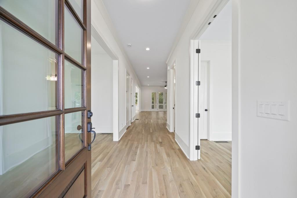 611 Foster Park Lane Madison, GA 30650 - Photo 5 of 54 a view of a hallway with wooden floor and staircase