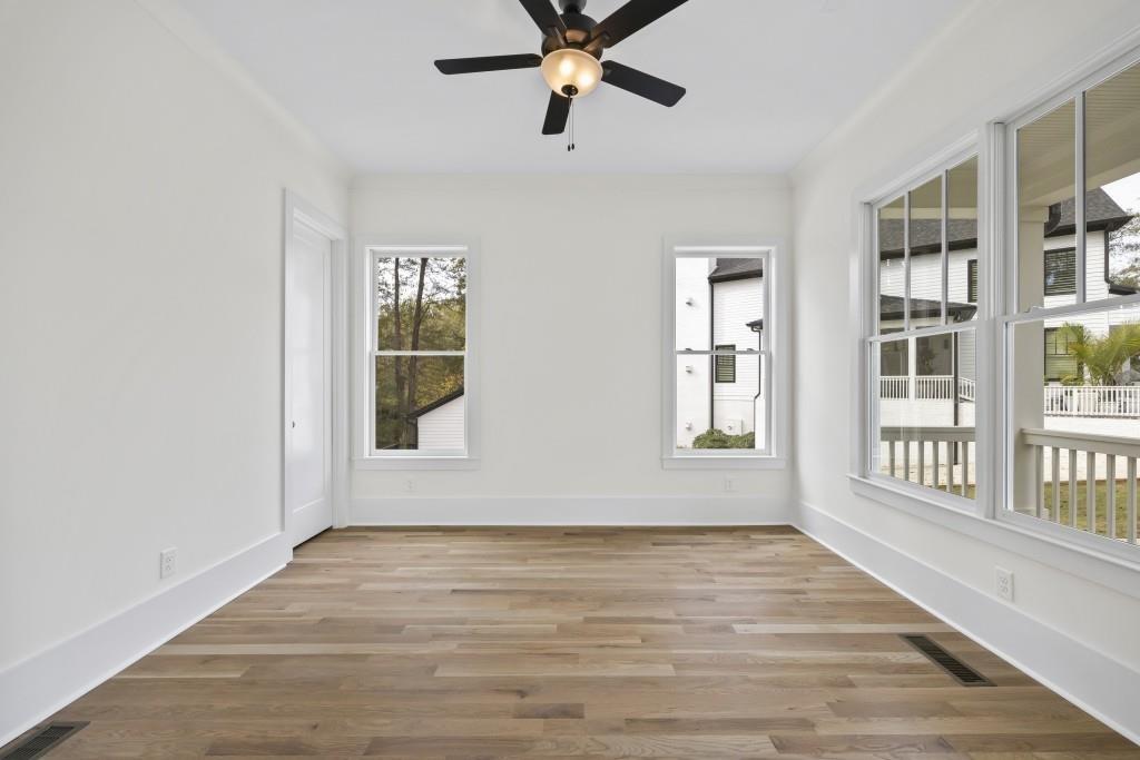 611 Foster Park Lane Madison, GA 30650 - Photo 7 of 54 a view of an empty room with a window and wooden floor
