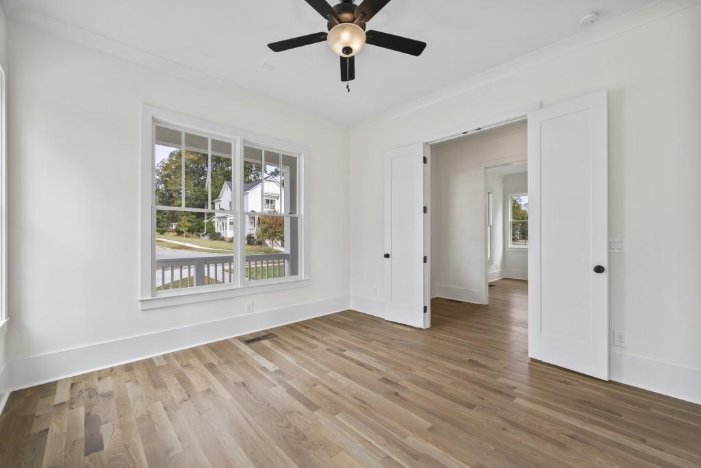611 Foster Park Lane Madison, GA 30650 - Photo 8 of 54 a view of an empty room with wooden floor and a window