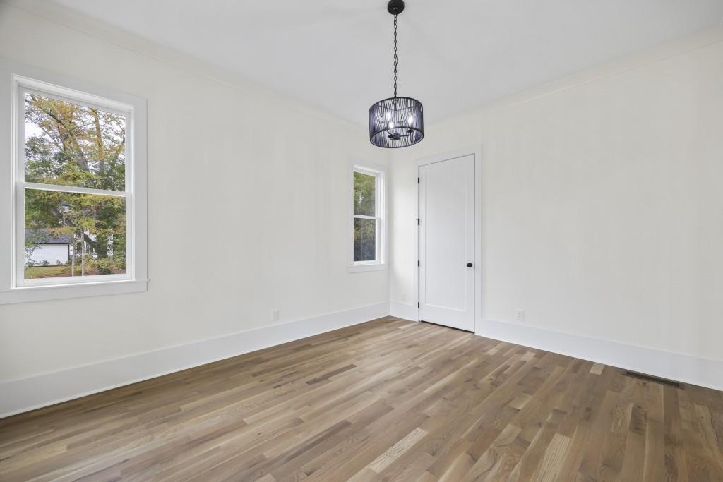 611 Foster Park Lane Madison, GA 30650 - Photo 10 of 54 a view of a room with a window and wooden floor