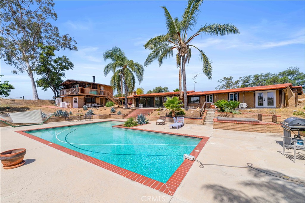 6308 Hawarden Drive Riverside, CA 92506 - Photo 34 of 37 a view of swimming pool with outdoor seating and house in the background