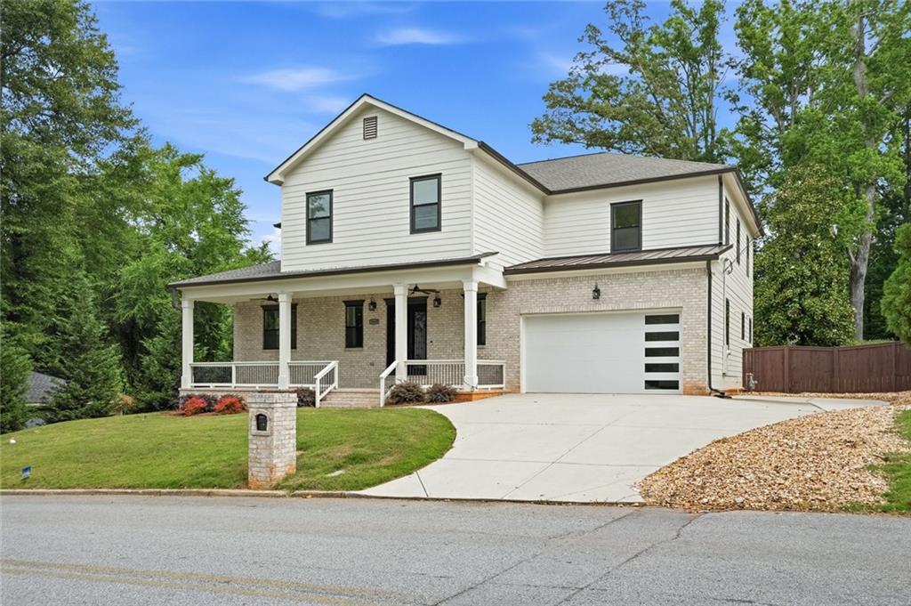 2415 West Rugby Avenue Atlanta, GA 30337 - Photo 2 of 40 a front view of a house with a yard and garage