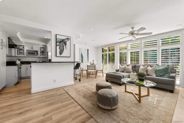 a living room with furniture and large windows