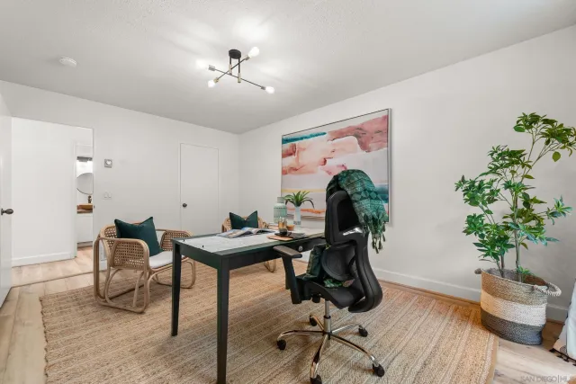 a view of a livingroom with furniture and a potted plant