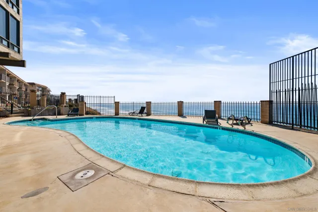 a view of a swimming pool with a yard
