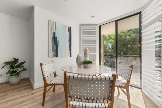 a view of a dining room with furniture window and wooden floor
