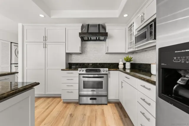 a kitchen with cabinets and appliances