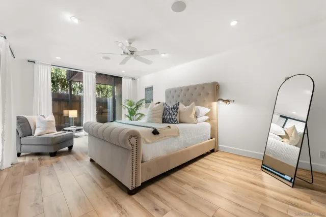 a bedroom with a bed wooden floor and furniture