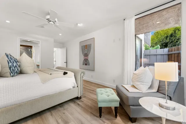 a bedroom with a bed a couch and a large mirror