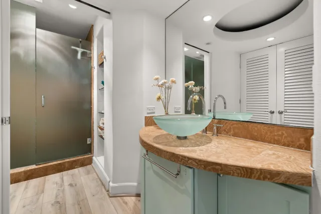 a bathroom with a granite countertop sink and a mirror