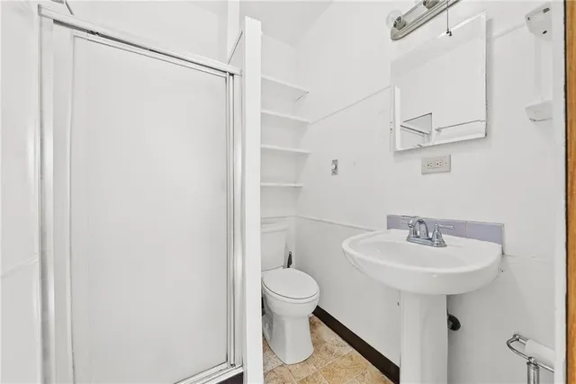 a bathroom with a sink toilet and a mirror