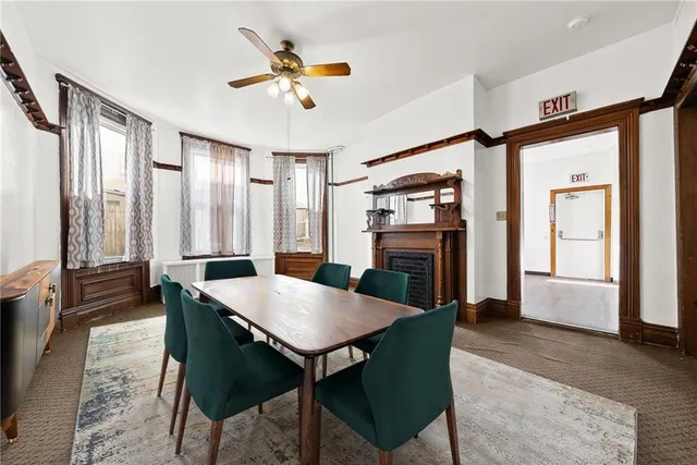 a view of a dining room with furniture and a chandelier