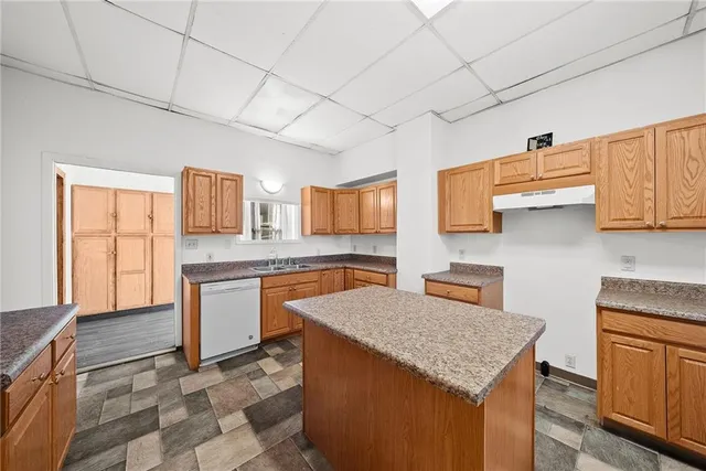 a kitchen with granite countertop a sink and cabinets
