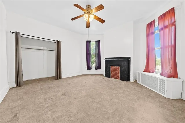 a view of a bedroom with a bed and a window