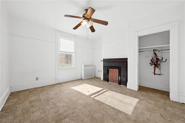 an empty room with closet and windows