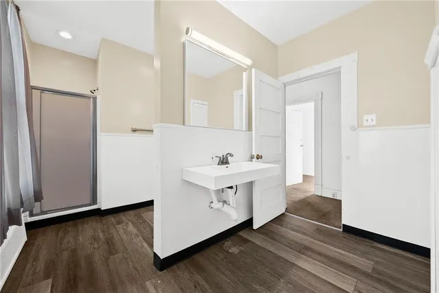 a bathroom with a bathtub and a shower