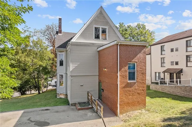 an aerial view of a house with a yard and lake view