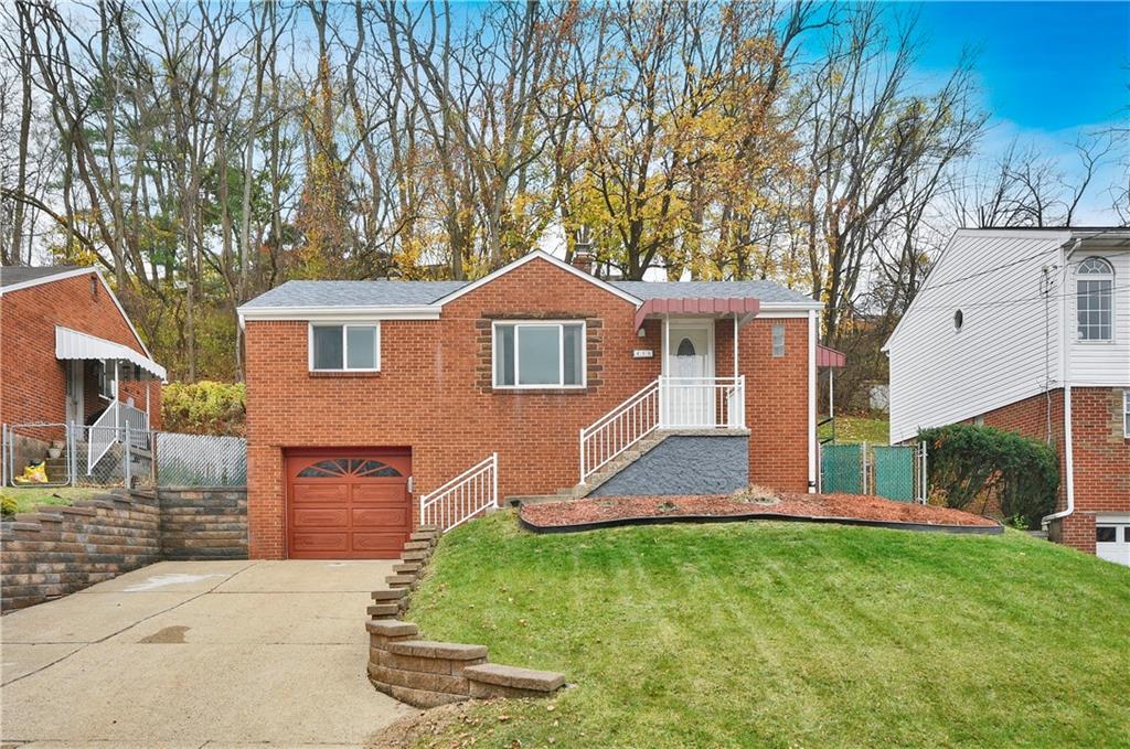 416 Pearce Road Pittsburgh, PA 15234 - Photo 1 of 32 a front view of a house with a yard and garage