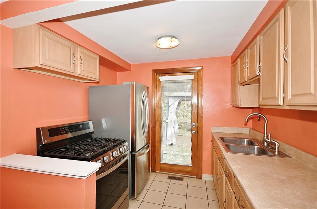 416 Pearce Road Pittsburgh, PA 15234 - Photo 13 of 32 a kitchen with stainless steel appliances granite countertop a stove and a sink