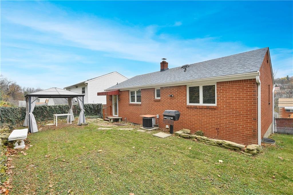 416 Pearce Road Pittsburgh, PA 15234 - Photo 27 of 32 a front view of a house with a yard patio and wooden fence