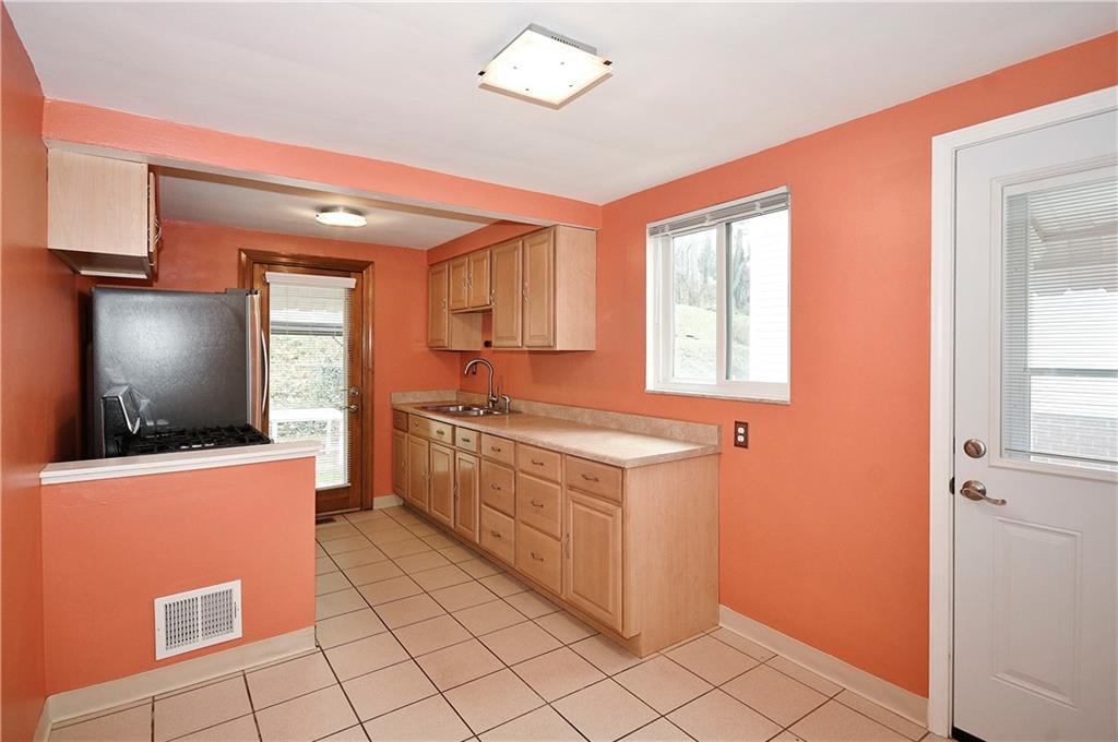 416 Pearce Road Pittsburgh, PA 15234 - Photo 10 of 32 a kitchen with stainless steel appliances a sink and a refrigerator