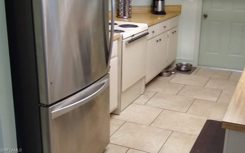 7659 Laurel Valley Road Fort Myers, FL 33967 - Photo 23 of 35 a kitchen with a sink and cabinets