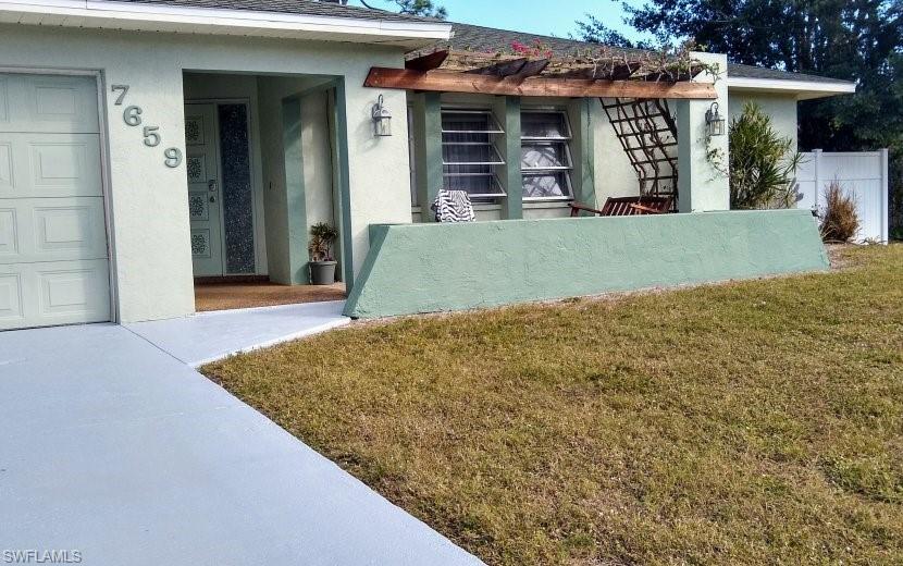 7659 Laurel Valley Road Fort Myers, FL 33967 - Photo 5 of 35 a view of a house with roof deck
