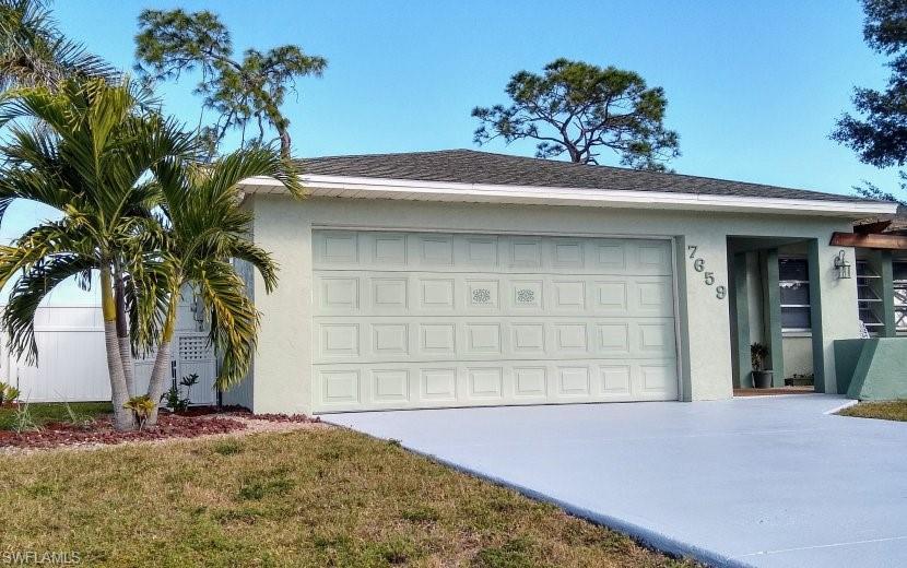 7659 Laurel Valley Road Fort Myers, FL 33967 - Photo 9 of 35 a front view of a house having yard